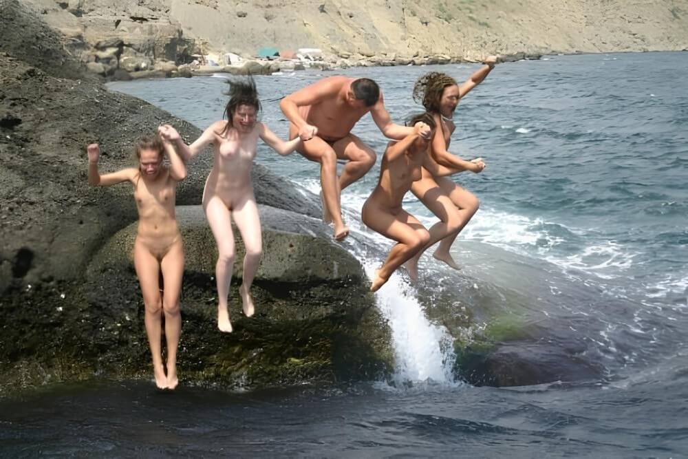 Mens and girls nudists on a beach - Where nudism is commonplace