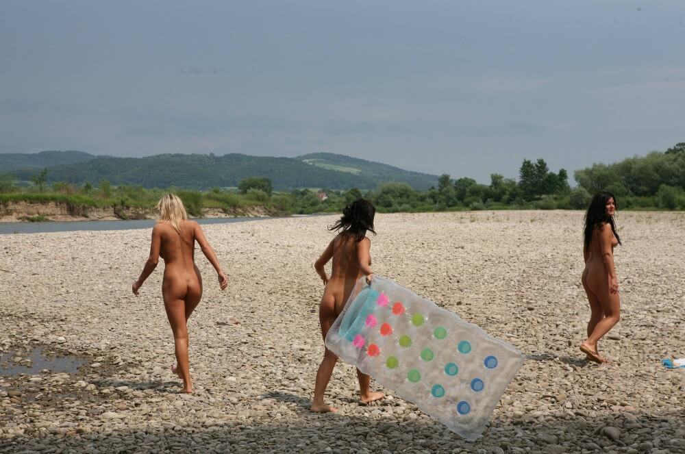 Naturist Park Floating On River photos - People who practice nudism also believe that everyone is equal, regardless of circumstances