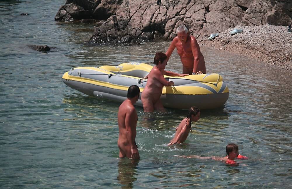 Lone Nudist in Yellow Boat photos - Nudism strengthens friendships and mutual respect
