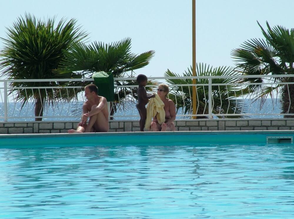 Photo of naturists in an outdoor pool - Nudism teaches you to appreciate the present